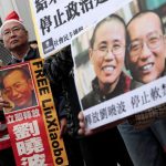 Pro-democracy demonstrators hold up photo of jailed Chinese Nobel Peace Prize laureate Liu Xiaobo during a protest to urge for the release of Liu, outside the Chinese liaison office in Hong Kong