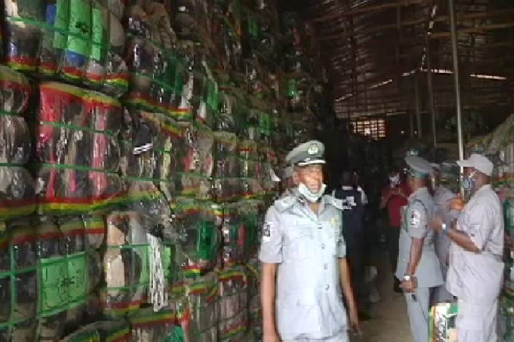 Customs strike force evacuates bales of second hand clothing from warehouse in Lagos